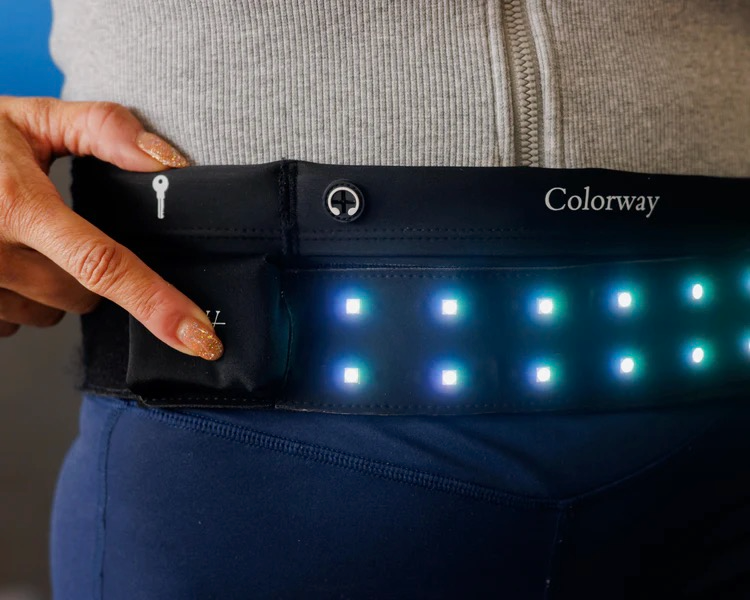 Illuminated Colorway LED belt with hand near battery pack